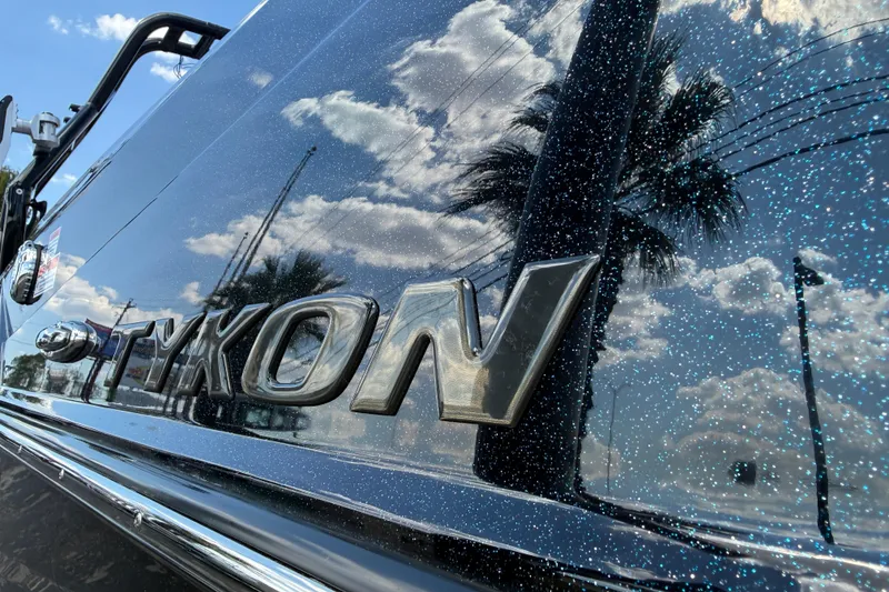 Slide: The Image of 2026 Moomba Tykon boat with reflective surface and sky reflection. - 10