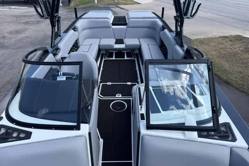 Slide: The Image of 2026 Moomba Tykon boat interior with sleek gray seating and open windshield design. - 16