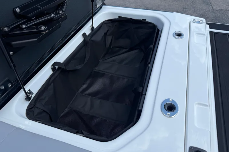 Slide: The Image of 2026 Moomba Tykon boat storage compartment with black interior and white exterior. - 18