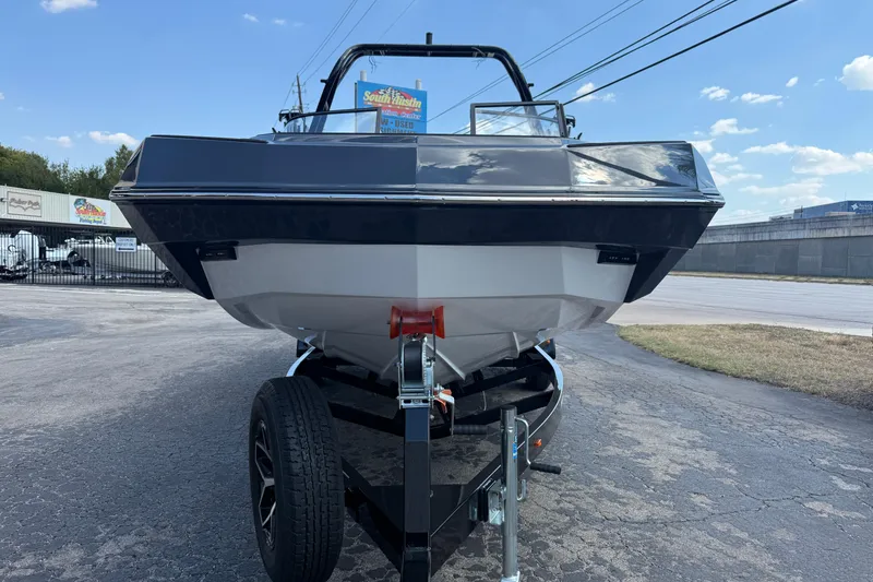Slide: The Image of 2026 Moomba Tykon boat on trailer, parked outdoors under a clear blue sky. - 2