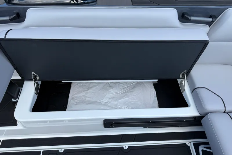 Slide: The Image of 2026 Moomba Tykon boat seat storage compartment, open with visible interior space. - 21
