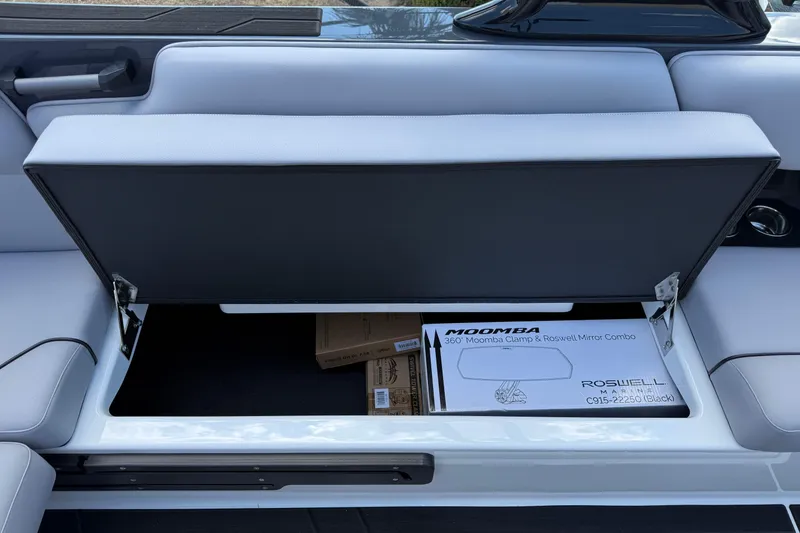 Slide: The Image of Open storage compartment in 2026 Moomba Tykon boat with Moomba clamp and Roswell mirror combo. - 23
