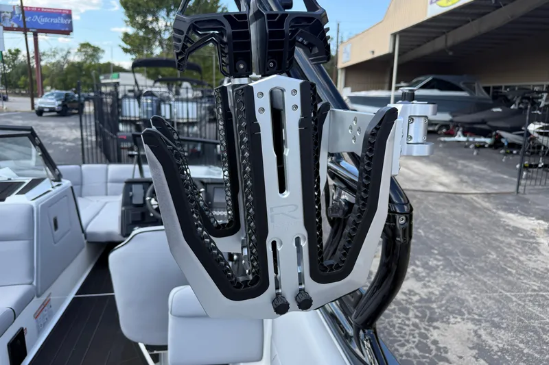 Slide: The Image of 2026 Moomba Tykon boat with advanced wakeboard rack in a showroom setting. - 26