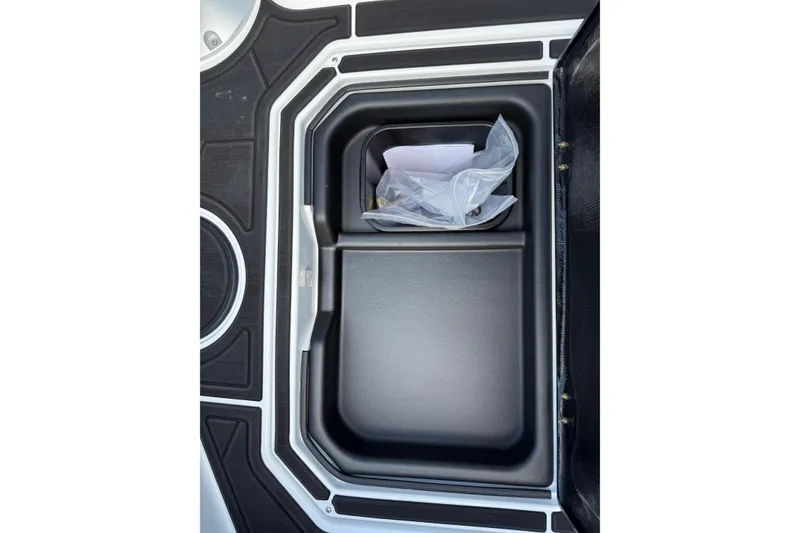 Slide: The Image of Storage compartment in 2026 Moomba Tykon boat, featuring sleek black interior design. - 30