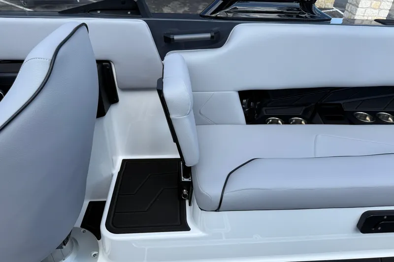 Slide: The Image of 2026 Moomba Tykon boat interior with sleek gray seating and cup holders. - 31