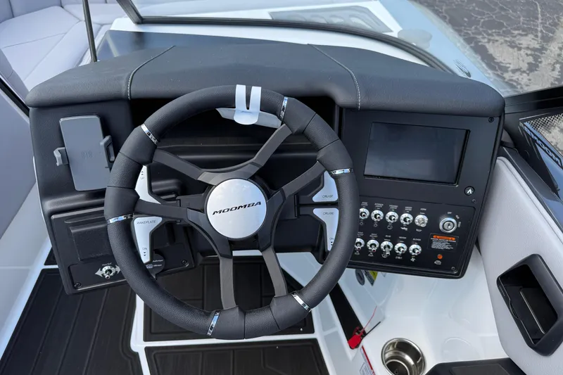 Slide: The Image of 2026 Moomba Tykon boat dashboard with steering wheel and control panel. - 32