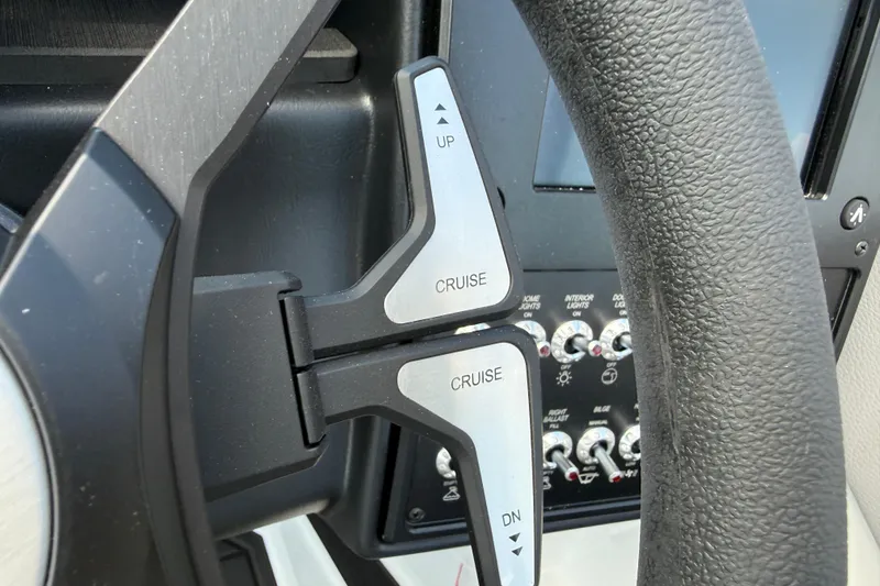 Slide: The Image of 2026 Moomba Tykon steering wheel with cruise control buttons, close-up view. - 33