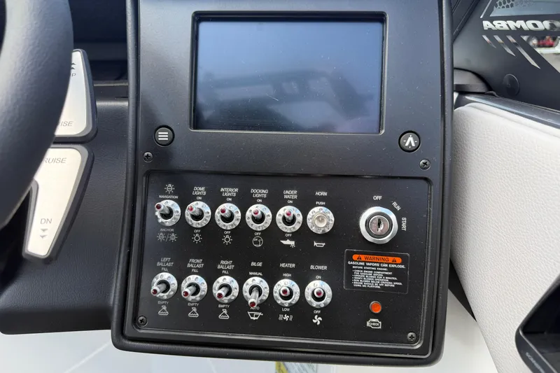 Slide: The Image of Control panel of 2026 Moomba Tykon boat with various switches and display screen. - 35