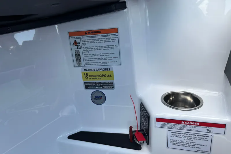 Slide: The Image of Interior of 2026 Moomba Tykon boat with safety warnings and capacity details. - 37