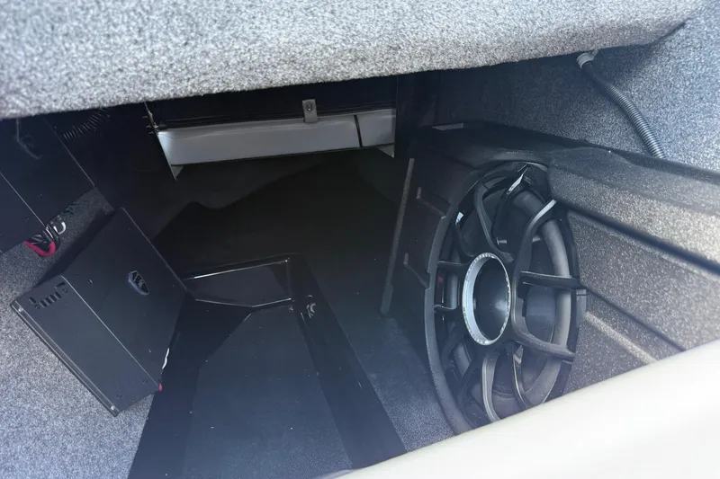 Slide: The Image of 2026 Moomba Tykon interior storage with subwoofer and electronic components. - 39