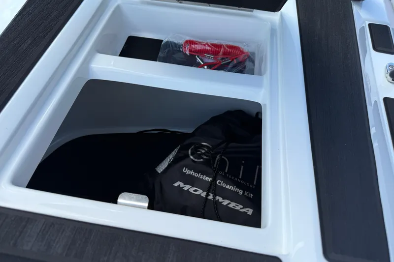 Slide: The Image of Storage compartment in 2026 Moomba Tykon boat with cleaning kit and accessories. - 41
