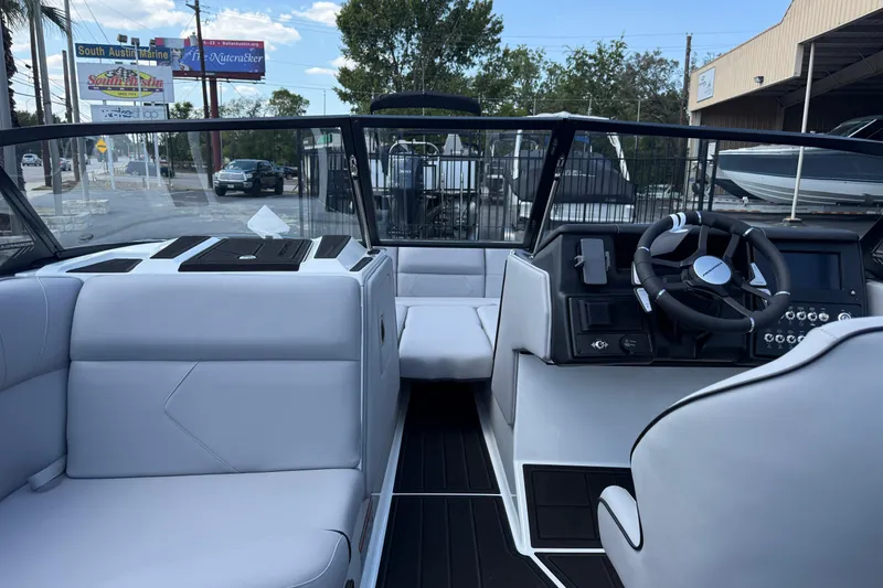 Slide: The Image of 2026 Moomba Tykon boat interior with modern steering and seating, displayed at South Austin Marine. - 42