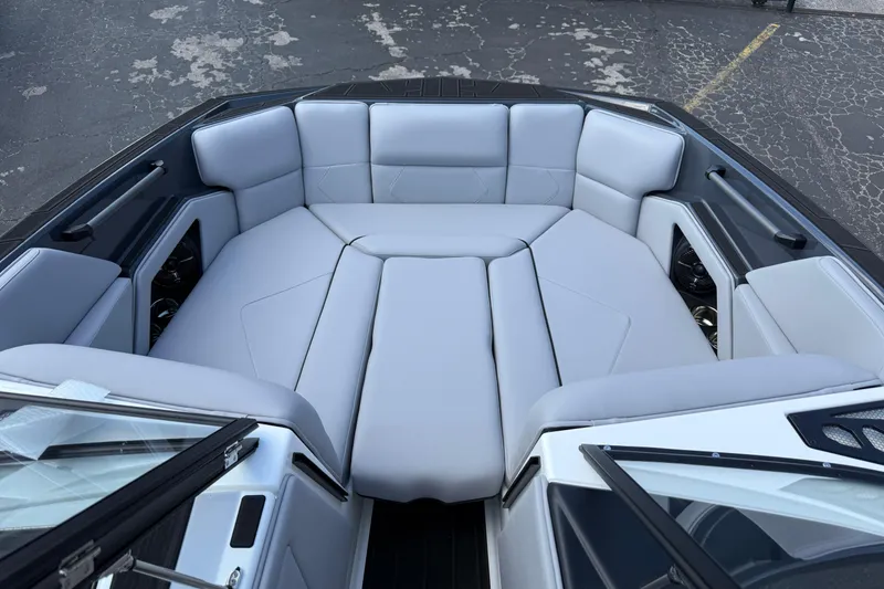 Slide: The Image of 2026 Moomba Tykon boat interior with spacious, cushioned seating in light gray upholstery. - 43