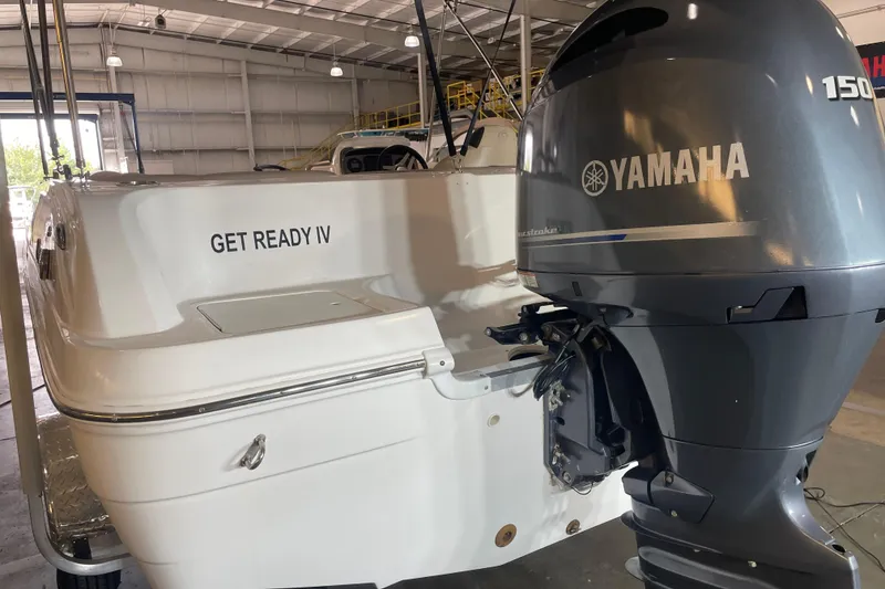 Slide: The Image of 2023 Hurricane SunDeck Sport 201 OB boat with Yamaha 150 engine in a warehouse. - 10