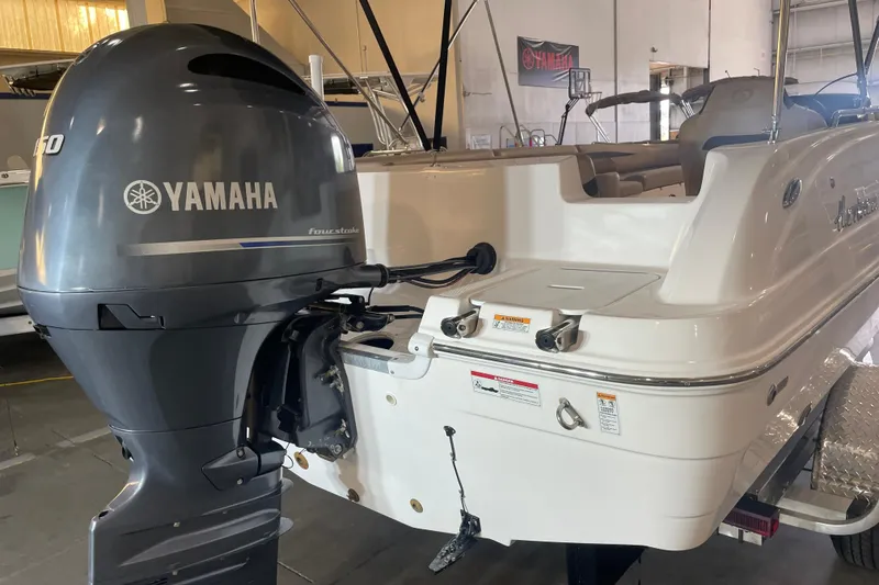 Slide: The Image of 2023 Hurricane SunDeck Sport 201 OB with Yamaha outboard motor in a showroom setting. - 11
