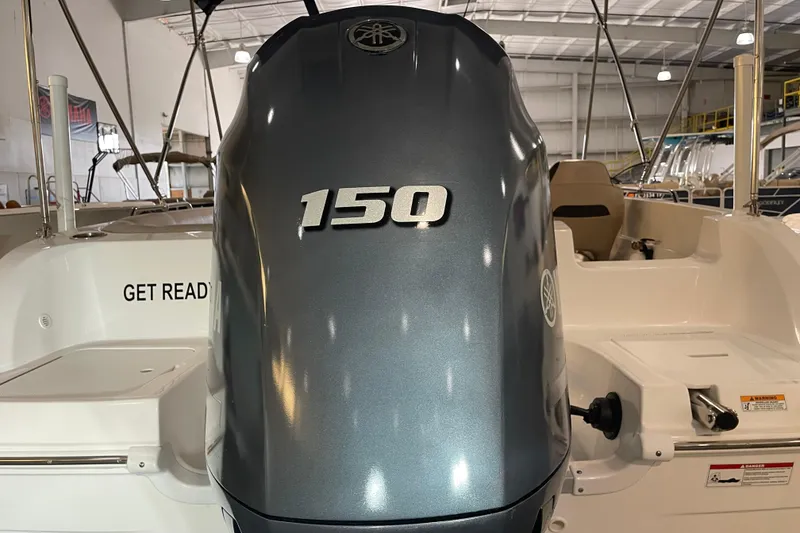 Slide: The Image of 2023 Hurricane SunDeck Sport 201 OB boat with 150 horsepower engine in showroom. - 13