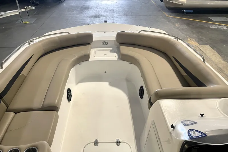 Slide: The Image of 2023 Hurricane SunDeck Sport 201 OB boat interior with beige seating in a showroom. - 15