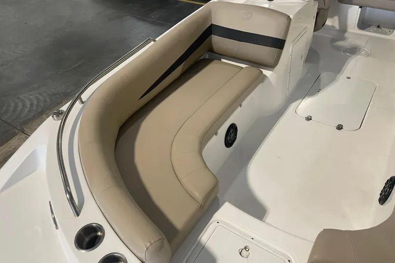 Slide: The Image of 2023 Hurricane SunDeck Sport 201 OB boat interior with beige seating and cup holders. - 17