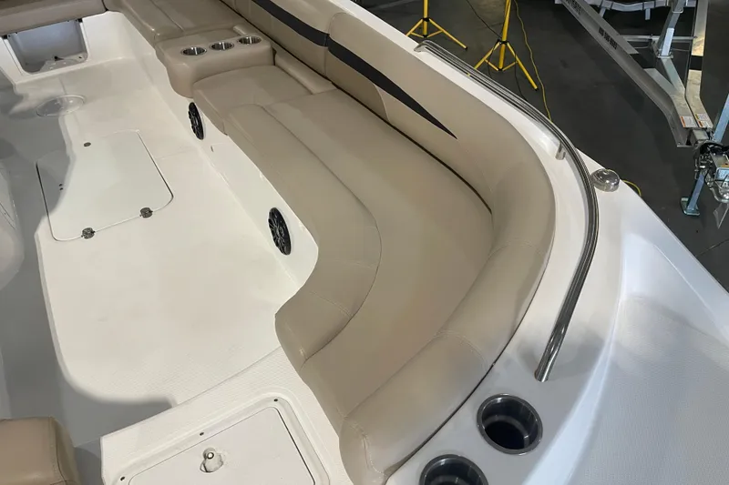 Slide: The Image of 2023 Hurricane SunDeck Sport 201 OB boat interior with beige seating and cup holders. - 18