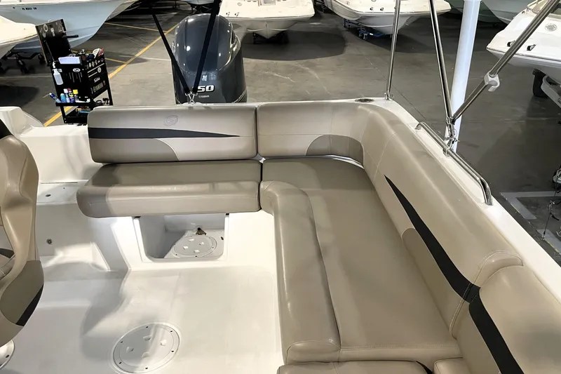 Slide: The Image of 2023 Hurricane SunDeck Sport 201 OB boat interior with beige seating and Yamaha engine. - 21