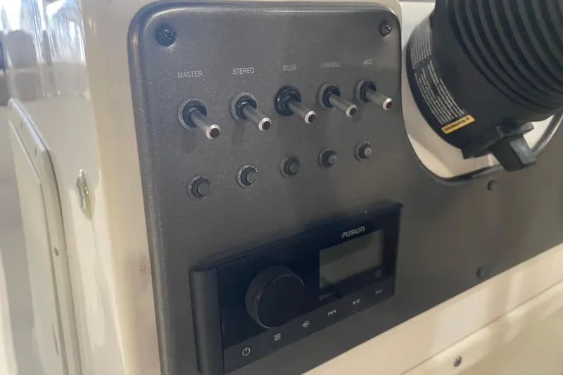 Slide: The Image of Control panel of 2023 Hurricane SunDeck Sport 201 OB boat with switches and stereo system. - 25