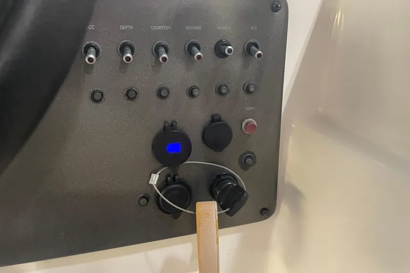 Slide: The Image of Control panel of 2023 Hurricane SunDeck Sport 201 OB boat with switches and dials. - 26