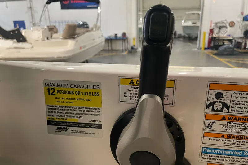 Slide: The Image of 2023 Hurricane SunDeck Sport 201 OB boat control panel with capacity and safety warnings. - 27