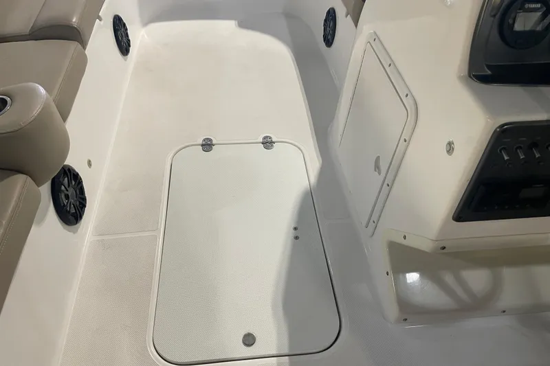 Slide: The Image of 2023 Hurricane SunDeck Sport 201 OB interior, featuring seating and storage compartments. - 29