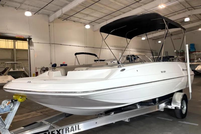 Slide: The Image of 2023 Hurricane SunDeck Sport 201 OB boat in indoor showroom on trailer. - 3