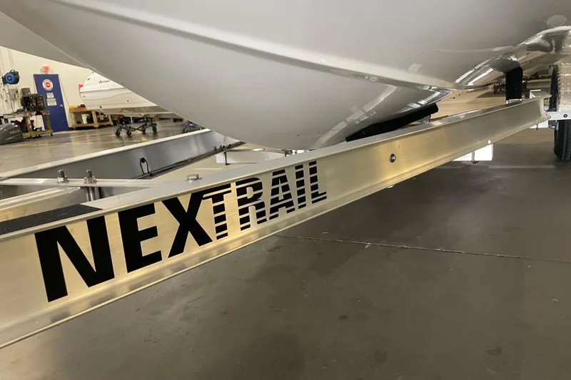 Slide: The Image of 2023 Hurricane SunDeck Sport 201 OB on NexTrail trailer in a workshop. - 31