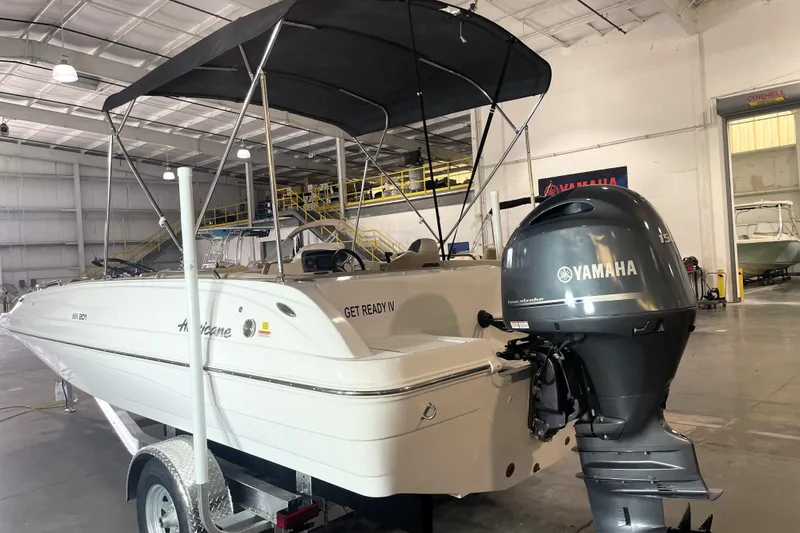 Slide: The Image of 2023 Hurricane SunDeck Sport 201 OB boat with Yamaha engine in a showroom. - 4