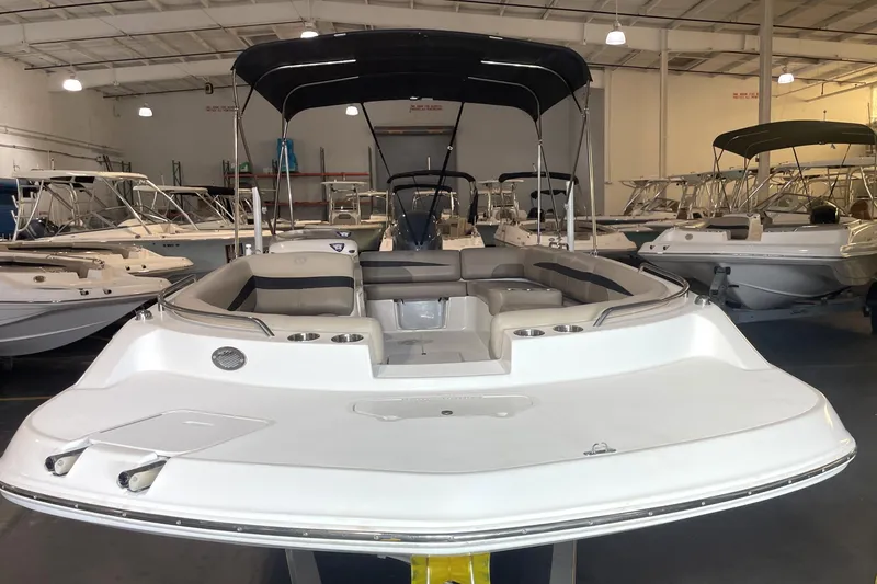 Slide: The Image of 2023 Hurricane SunDeck Sport 201 OB boat in showroom, featuring spacious seating and sleek design. - 5
