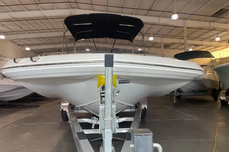 Slide: The Image of 2023 Hurricane SunDeck Sport 201 OB boat on trailer in indoor storage. - 6