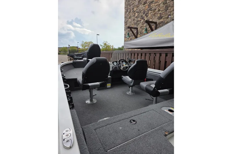 Slide: The Image of 2018 Crestliner 1650 Fish Hawk SC boat interior with seating and steering console. - 4