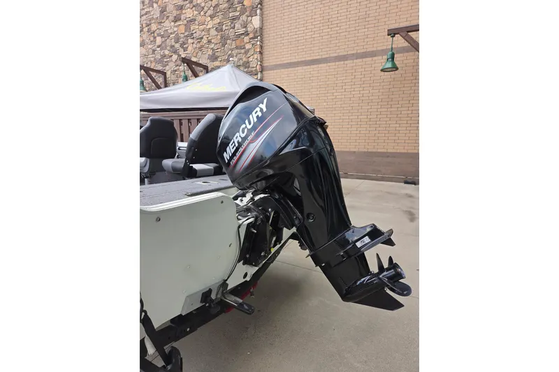 Slide: The Image of 2018 Crestliner 1650 Fish Hawk SC with Mercury outboard motor, parked outdoors. - 5