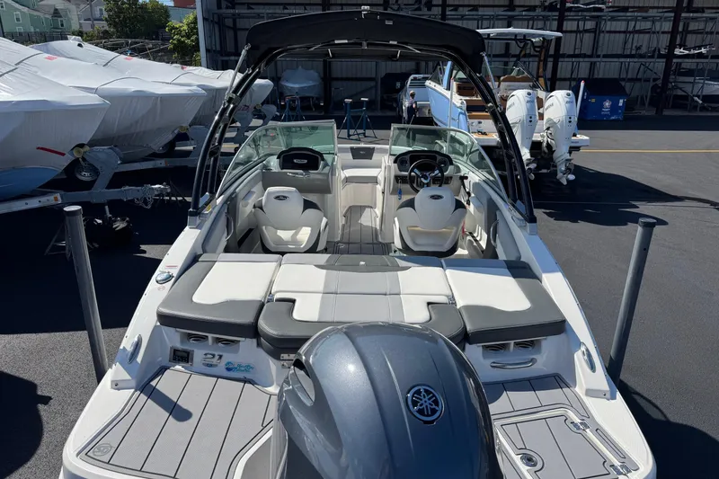 Slide: The Image of 2023 Chaparral 21 SSi OB boat with Yamaha outboard engine, docked in a marina. - 16