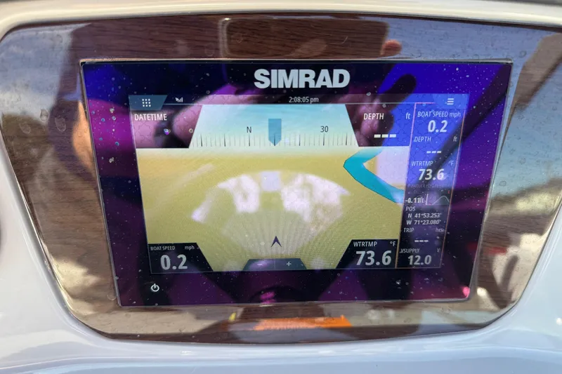 Slide: The Image of Simrad navigation display on 2023 Chaparral 21 SSi OB boat dashboard. - 7