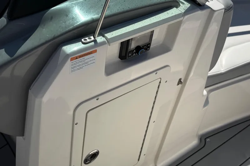 Slide: The Image of 2023 Chaparral 21 SSi OB boat interior detail with control panel and warning label. - 9