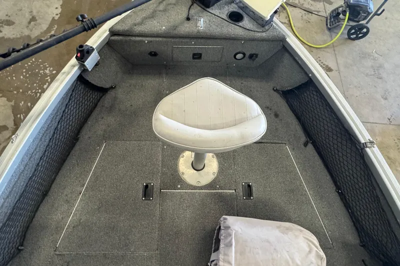 Slide: The Image of 2013 Alumacraft Competitor 165 Sport boat interior with swivel seat and storage compartments. - 10