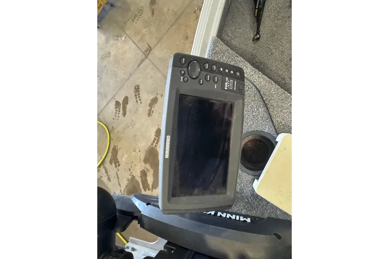 Slide: The Image of Fishfinder on 2013 Alumacraft Competitor 165 Sport boat, with visible footprints on the floor. - 13