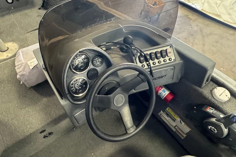 Slide: The Image of 2013 Alumacraft Competitor 165 Sport boat dashboard with steering wheel and control panel. - 6