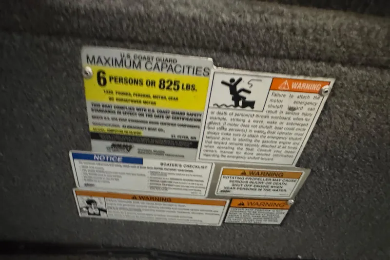 Slide: The Image of 2013 Alumacraft Competitor 165 Sport capacity and safety warning labels. - 7