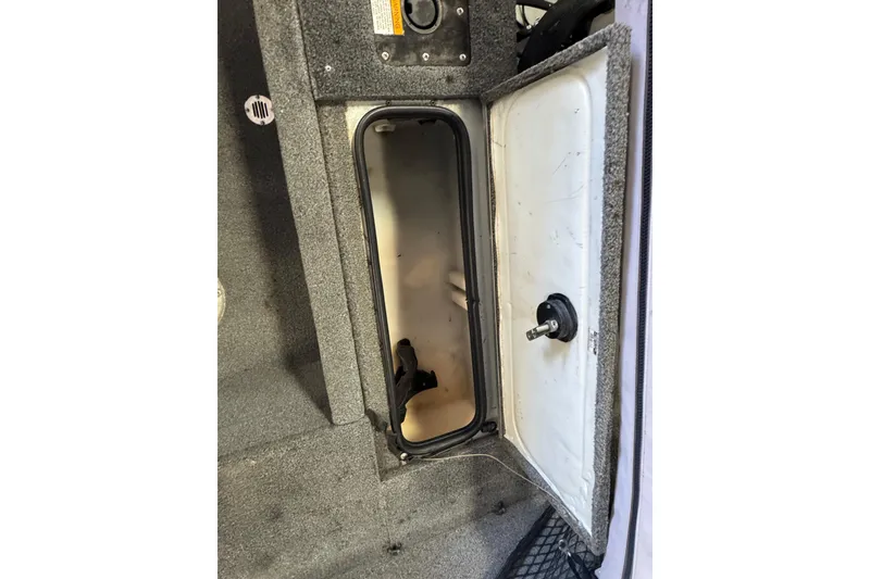 Slide: The Image of Open storage compartment in 2013 Alumacraft Competitor 165 Sport boat interior. - 9