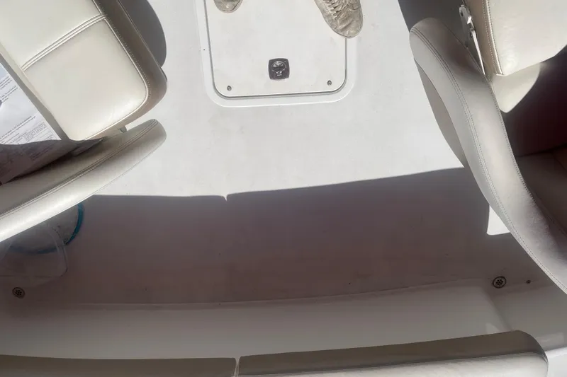 Slide: The Image of Interior of a 2011 Cobalt 210 boat with white leather seats. - 12