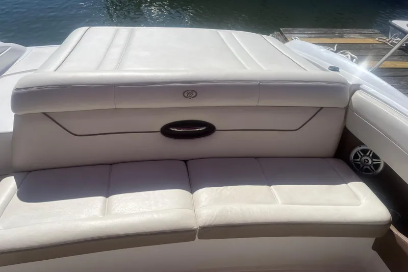 Slide: The Image of 2011 Cobalt 210 boat with white leather seating, docked by the water. - 6