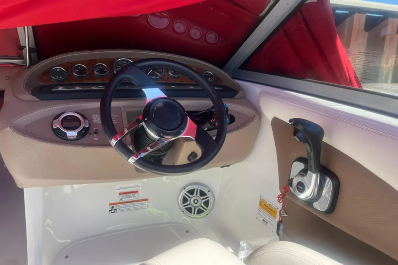 Slide: The Image of Interior of a 2011 Cobalt 210 boat showing steering wheel and control panel. - 7