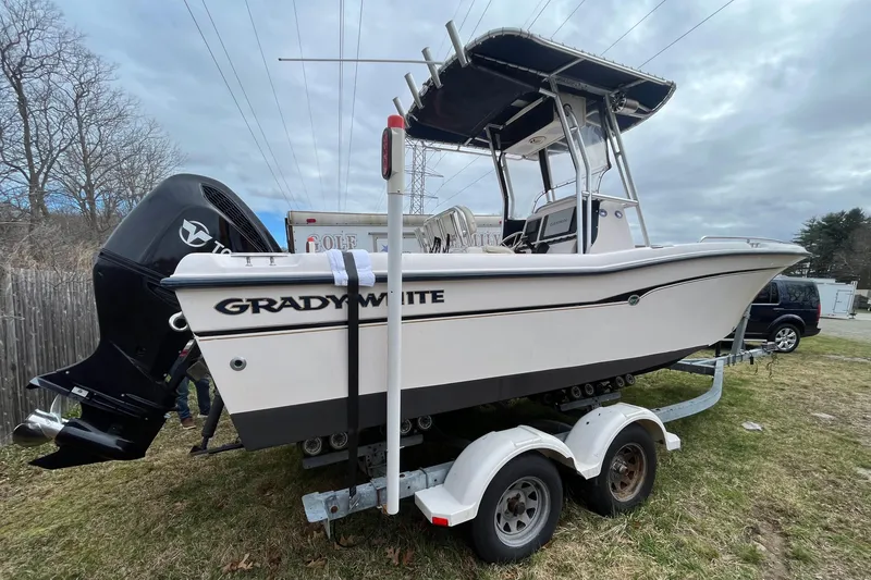 Slide: The Image of 2003 Grady-White Fisherman 222 boat on trailer, parked on grass. - 2