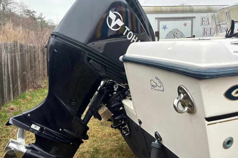 Slide: The Image of 2003 Grady-White Fisherman 222 with Tohatsu outboard motor, parked on grass. - 4