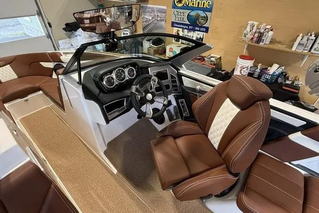 Slide: The Image of 2023 MasterCraft XT23 boat interior with brown leather seats and modern dashboard. - 4
