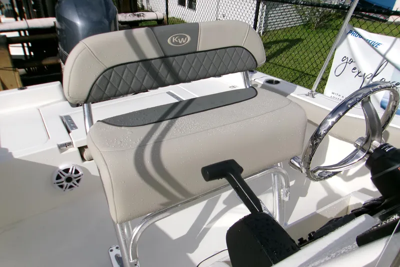 Slide: The Image of 2026 Key West 179 FS boat interior with steering wheel and cushioned seating. - 10